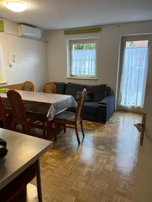 a living room with a table and a couch at Mirni kotiček in Čatež ob Savi