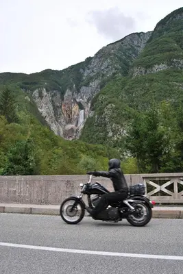a person riding a motorcycle down a road at Apartment House Cviter in Bovec