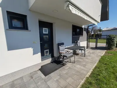 a patio with a table and chairs next to a house at Studio Hathor - Bikers Welcome in Kranj