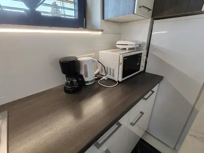 a kitchen counter with a microwave and a coffee maker at Studio Hathor - Bikers Welcome in Kranj