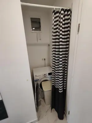 a small room with a desk and a curtain at Studio Hathor - Bikers Welcome in Kranj