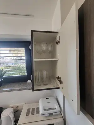 a kitchen with a counter with glasses and a mirror at Studio Hathor - Bikers Welcome in Kranj