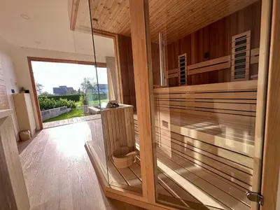 a pivot door in a room with a view at DESIREE with Sauna&HotTube at Potatoland Lux Resort in Šenčur