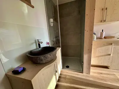 a bathroom with a sink and a shower at DESIREE with Sauna&HotTube at Potatoland Lux Resort in Šenčur