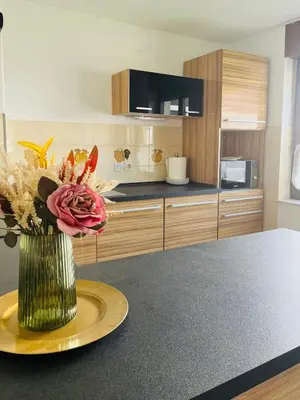 a kitchen with a vase of flowers on a table at Apartma Špan in Zgornje Gorje