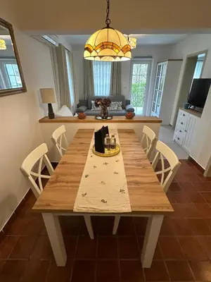a wooden table in a kitchen with a dining room at Bella Mura Nature Apartment Lipa 109 in Podčetrtek