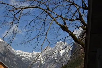 a view of a snow covered mountain through a window at House Pod Lipo in Trenta