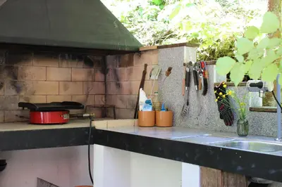 a kitchen with a sink and a counter top with utensils at Unique Forest Lodge Bled in Bled