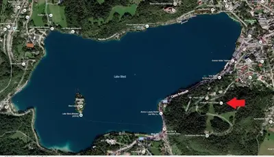 a map of a lake with a red square at Unique Forest Lodge Bled in Bled