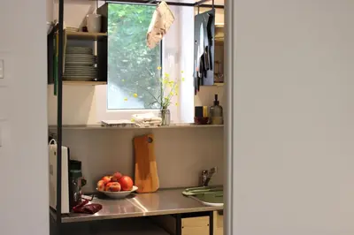 a kitchen with a table with a bowl of fruit on it at Unique Forest Lodge Bled in Bled
