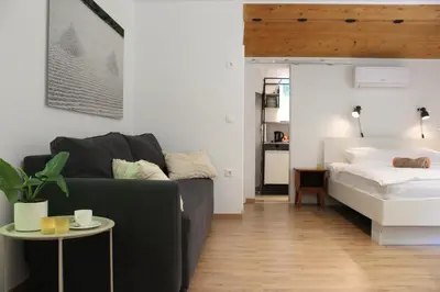 a living room with a couch and a bed at Unique Forest Lodge Bled in Bled