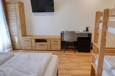 a bedroom with a bed and a desk with a computer at Domačija Kveder in Cerklje na Gorenjskem