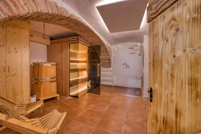 a hallway with wooden cabinets and a tile floor at Domačija Kveder in Cerklje na Gorenjskem