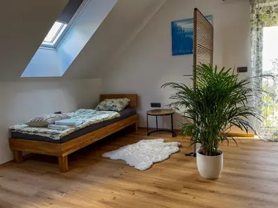 a bedroom with a bed and a potted plant at Vila Vinita in Sveti Jurij ob Ščavnici