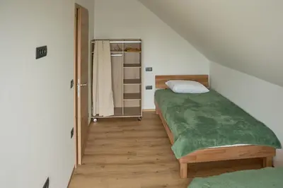 a small room with a bed and a closet at Vila Vinita in Sveti Jurij ob Ščavnici