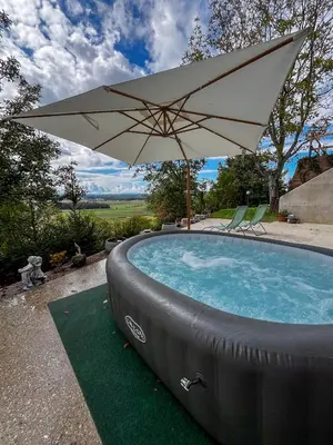 a pool with an umbrella and two chairs and a table at Vila Vinita in Sveti Jurij ob Ščavnici