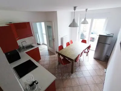 a kitchen and dining room with a table and chairs at Apartment Wild Soca No 7 in Bovec