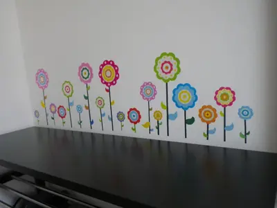 a wall with a bunch of flowers painted on it at Apartment Wild Soca No 7 in Bovec