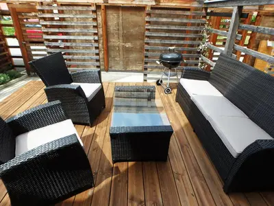 a patio with chairs and a table and a grill at Apartment Wild Soca No 7 in Bovec