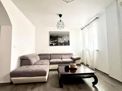 a living room with a couch and a table at Apartment Lucija - Dekani in Dekani