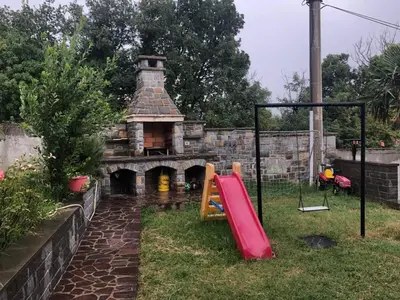 a playground with a slide in front of a building at Apartment Lucija - Dekani in Dekani
