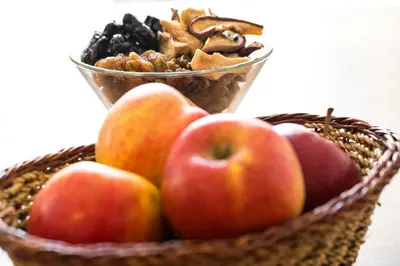 a basket of apples and nuts with a bowl of nuts at Old Parish House in Bled