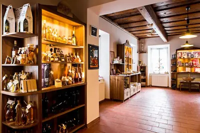 a room filled with shelves filled with lots of wine bottles at Old Parish House in Bled
