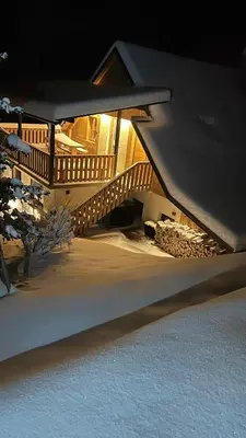 a snow covered staircase in a house at night at Grannys Retreat in Žiri