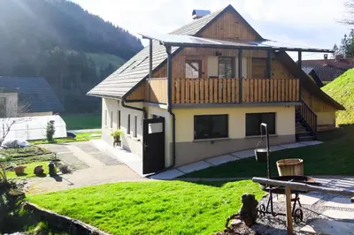 a house on a hill with a picnic table in front of it at Grannys Retreat in Žiri
