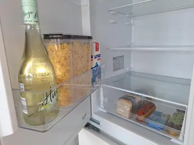 an open refrigerator with a bottle of champagne and food at Šipk -FREE-PARKING-BREAKFAST-TERRACE in Vojnik