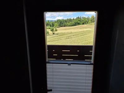 a window in a bathroom with a view of a field at Šipk -FREE-PARKING-BREAKFAST-TERRACE in Vojnik