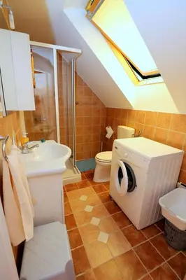 a bathroom with a sink toilet and a skylight at BledRoom in Bled
