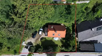 an aerial view of a house with a car in the yard at BledRoom in Bled