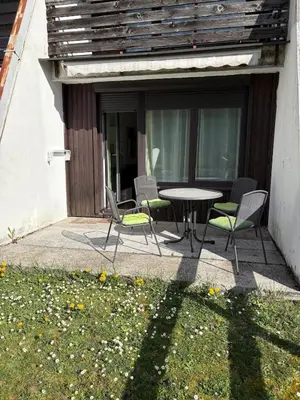 a patio with a table and chairs on a patio at Stefs Garden in Bovec