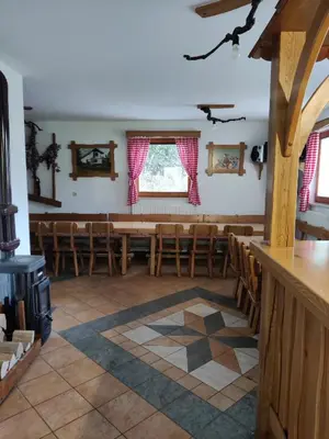 a room with a row of chairs in a church at Countryside house in Male Brusnice