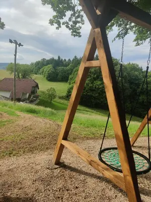 a swing seat with a view of a yard at Countryside house in Male Brusnice