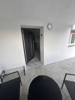 a room with a clock on the wall and a chair at Stanojkov in Bovec