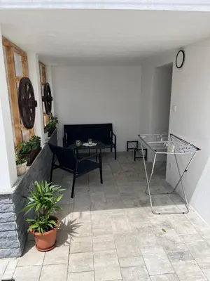 a patio with a glass table and a couch at Stanojkov in Bovec