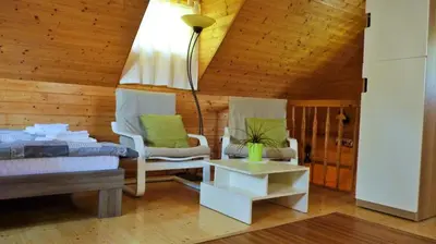 a living room with two chairs and a table at Lodge Bled in Bled