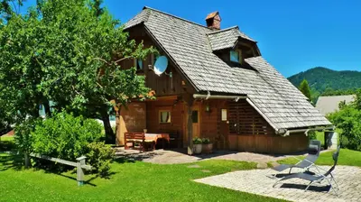 a log cabin with a shingled roof at Lodge Bled in Bled