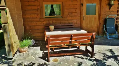 a bench sitting outside of a building with a window at Lodge Bled in Bled