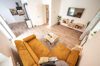 an overhead view of a living room with a couch and a table at Apartma med krošnjami in Bohinj