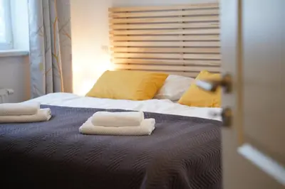 a bedroom with a bed with two towels on it at Apartma med krošnjami in Bohinj