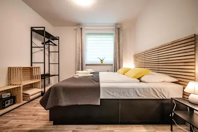 a bedroom with a large bed and a window at Apartma med krošnjami in Bohinj