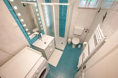 a small bathroom with a toilet and a sink at Apartma med krošnjami in Bohinj