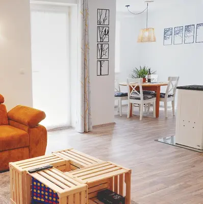 a living room with a couch and a table at Apartma med krošnjami in Bohinj