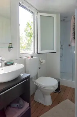 a bathroom with a toilet and a sink and a window at Panoramablick 360 Grad in den Weinbergen in Tržec