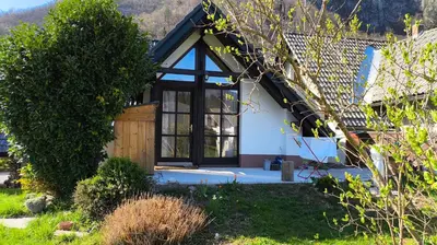a house with a large window and a door at Fresh romance by the river in Bohinj