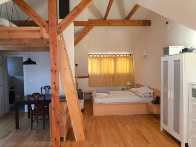 a bedroom with a bed and a table in a room at Fresh romance by the river in Bohinj