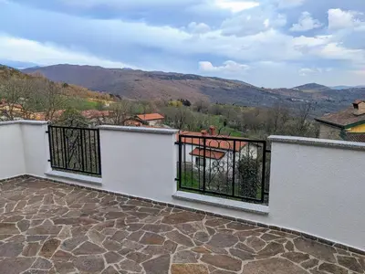 a balcony with a view of the mountains at Apartment Senik in Grgar